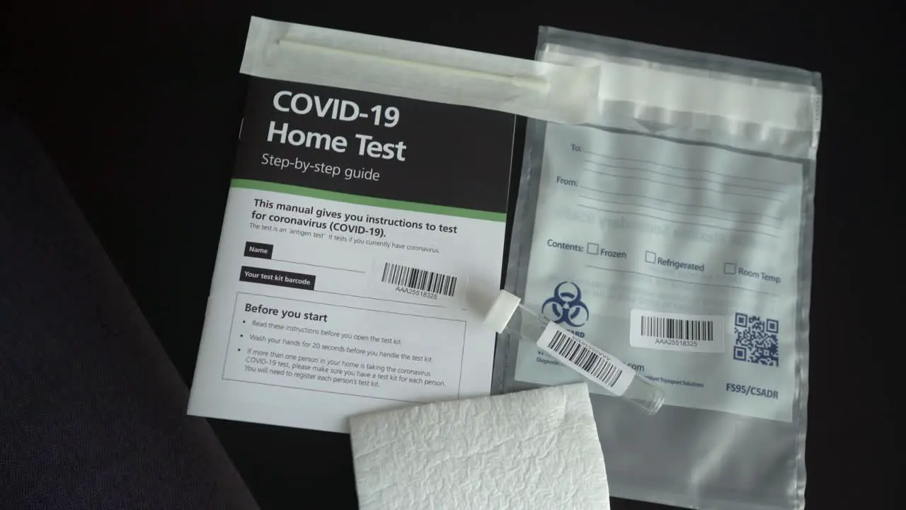 Covid-19 Coronavirus home test kit with guide test tube and cotton q tip on the table