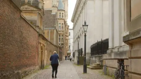 Tracking Shot Following Pedestrian Walking Down Quiet Street 