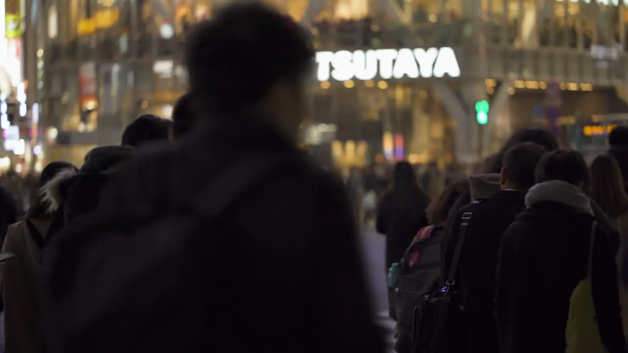 Group of pedestrians waiting to cross Shibuya scramble at night in Tokyo Japan