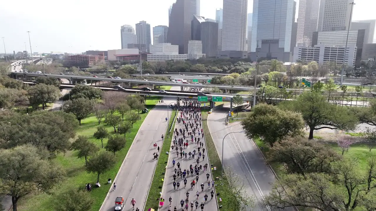 Top down Aerial of people competing in city marathon on the main road