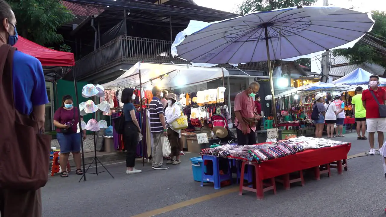 People standing still as National Anthem is played on market in Thailand