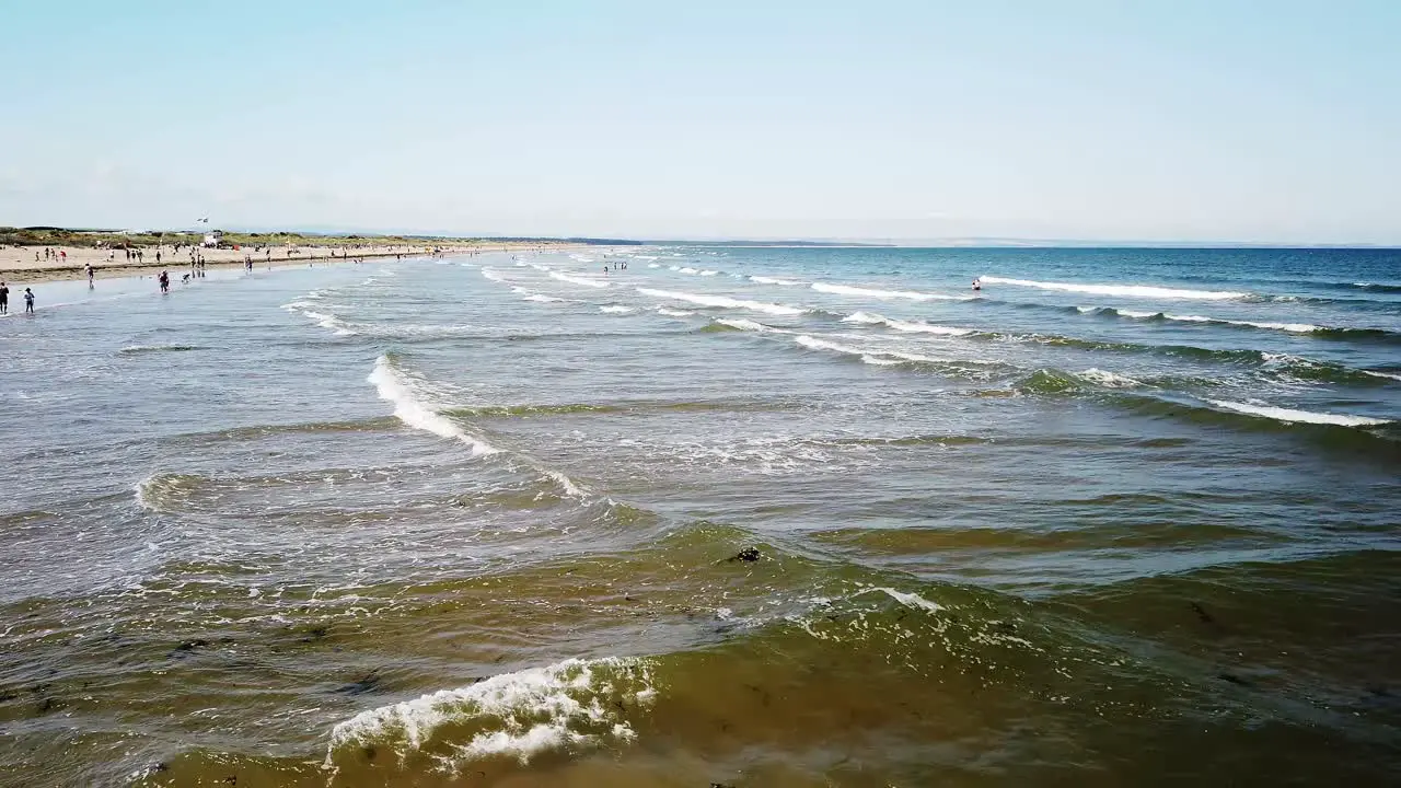 West sands St Andrews Fife Scotland with gentle waves sand and sun