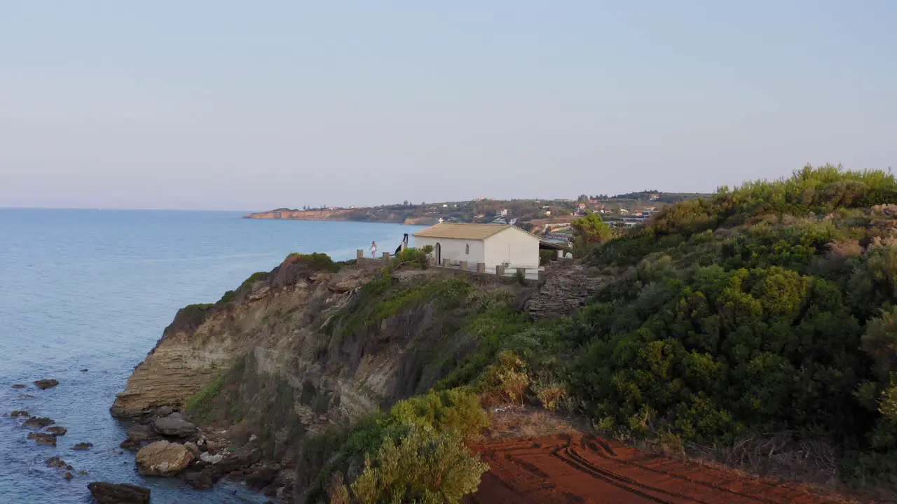 Woman Taking Pictures on the Edge of a Cliff Aerial