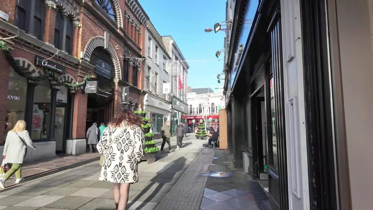 Pedestrians in slow motion on the street of Cork City Ireland near English market