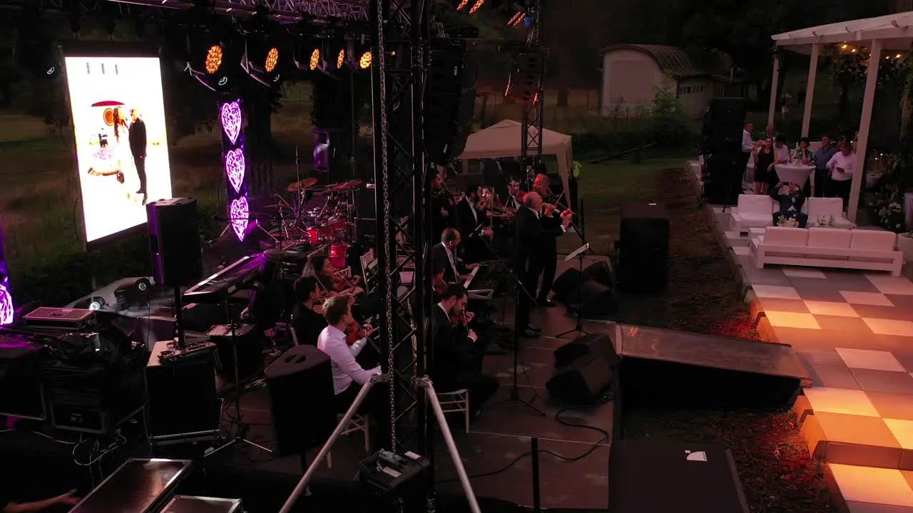 Orchestra playing at a wedding party while guests watch