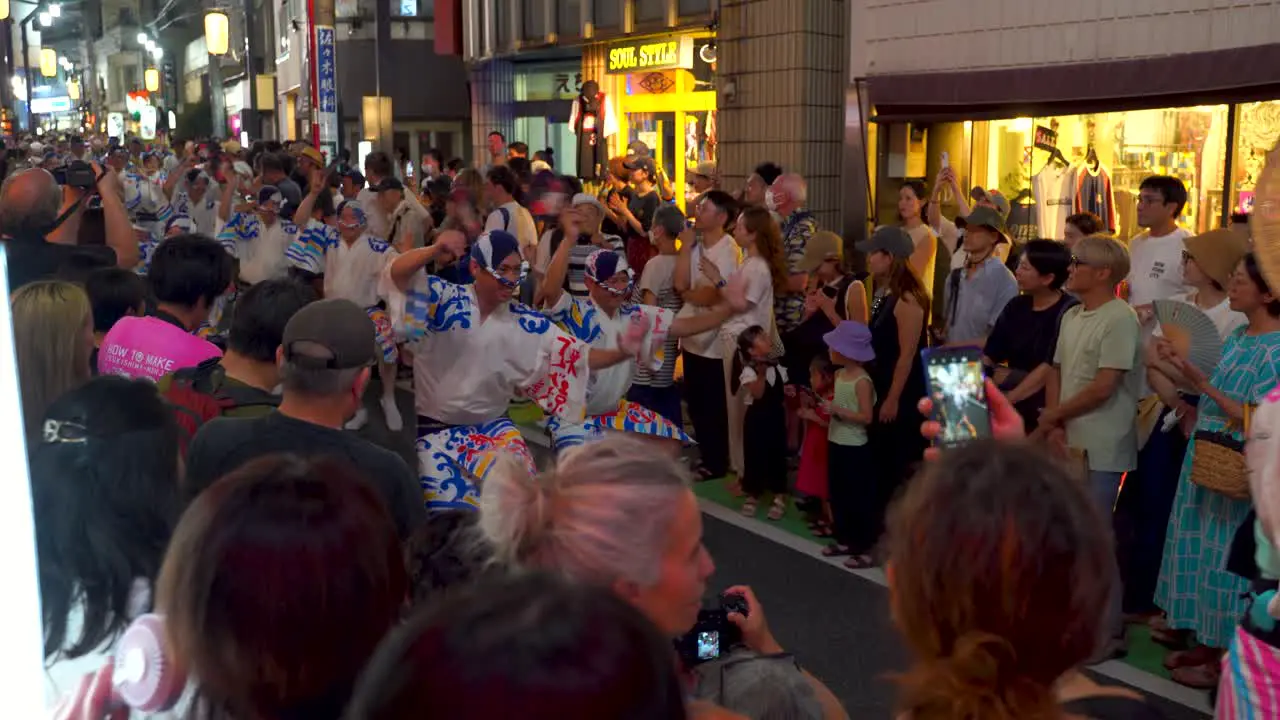 Traditional Japanese parade dancing through tight streets in Tokyo