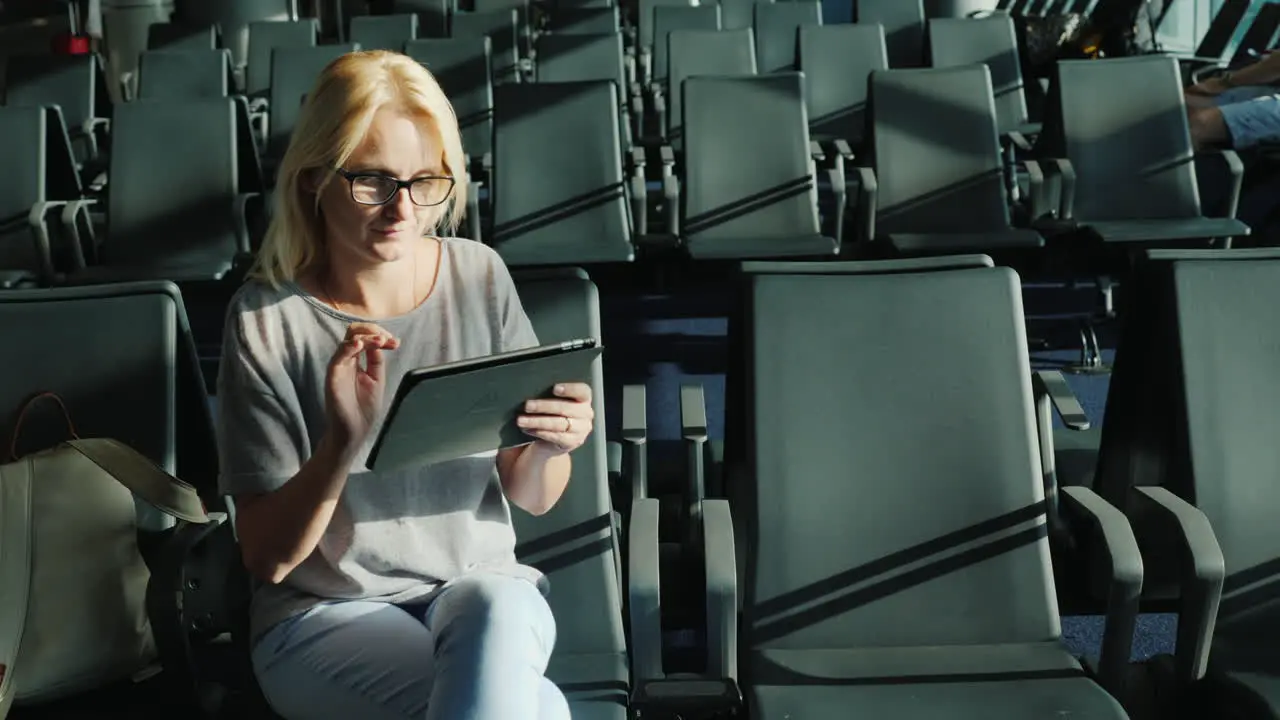 Woman in Airport Gate Uses Tablet