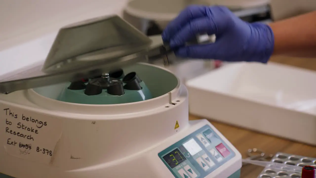 Blood Analysis in Action UK Doctor Using Centrifuge Machine