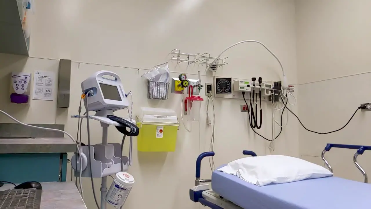 An empty hospital room stands equipped and ready to accept a patient