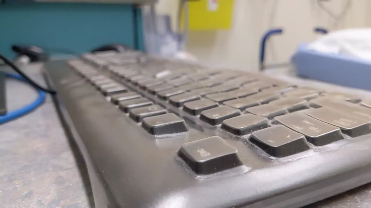 Slow pan up over keyboard in a hospital room