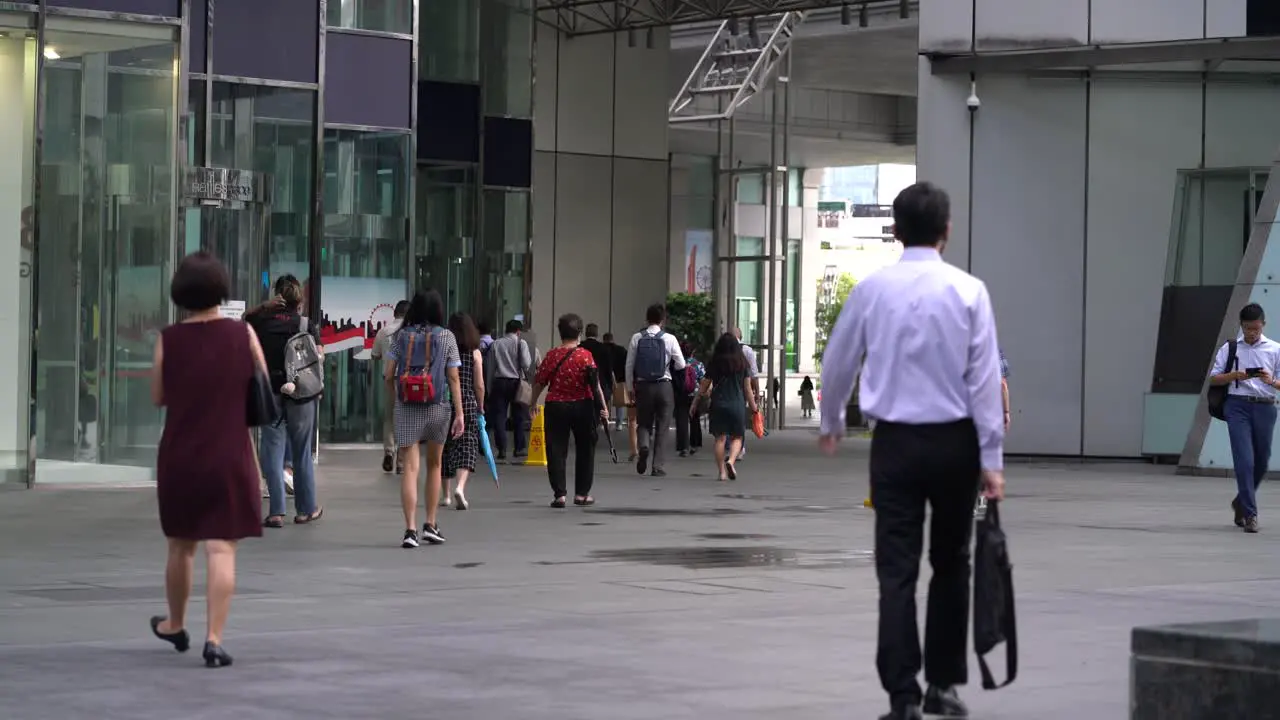 Office workers walking at Raffles Place downtown Singapore central business district