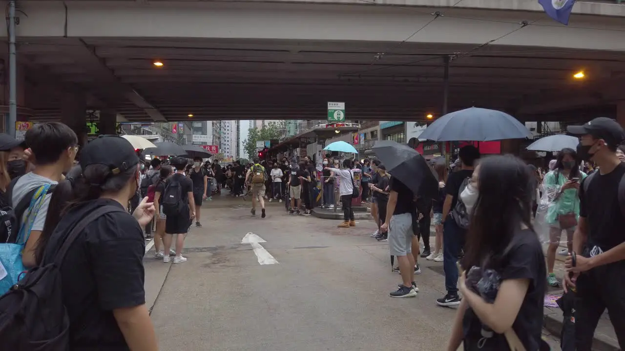 Follow Pan of First Aider running past the crowd Hong Kong protests