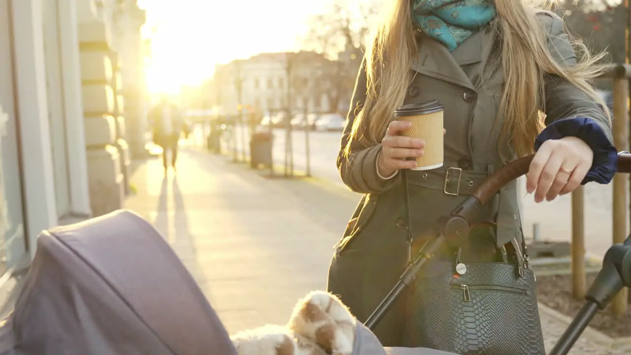 Mother enjoys hot cup of coffee on a cold autumn morning