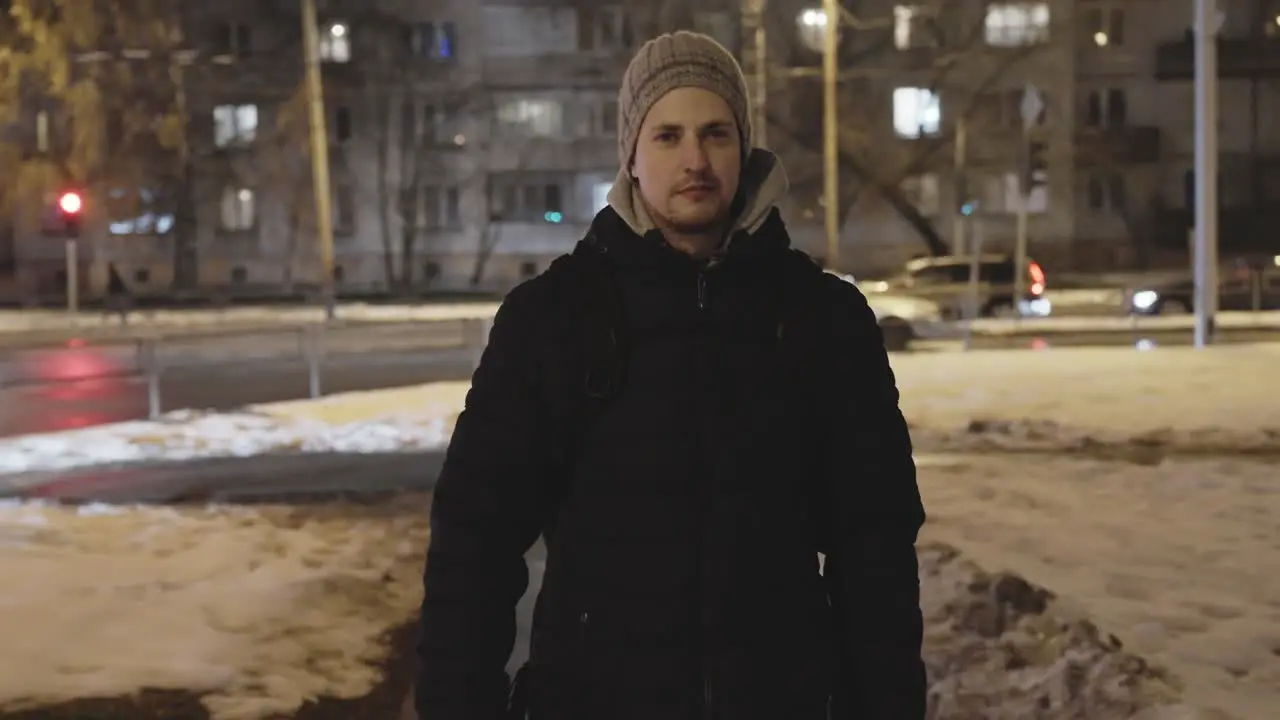 Determined and successful man in black jacket walk toward camera in urban scene