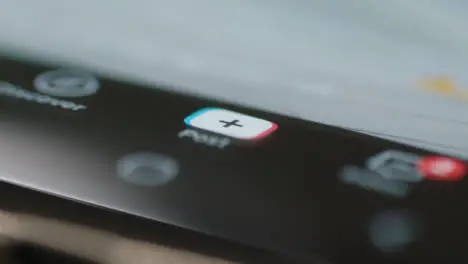 Extreme Close Up of Finger Pressing Tik Tok Post Button on Phone