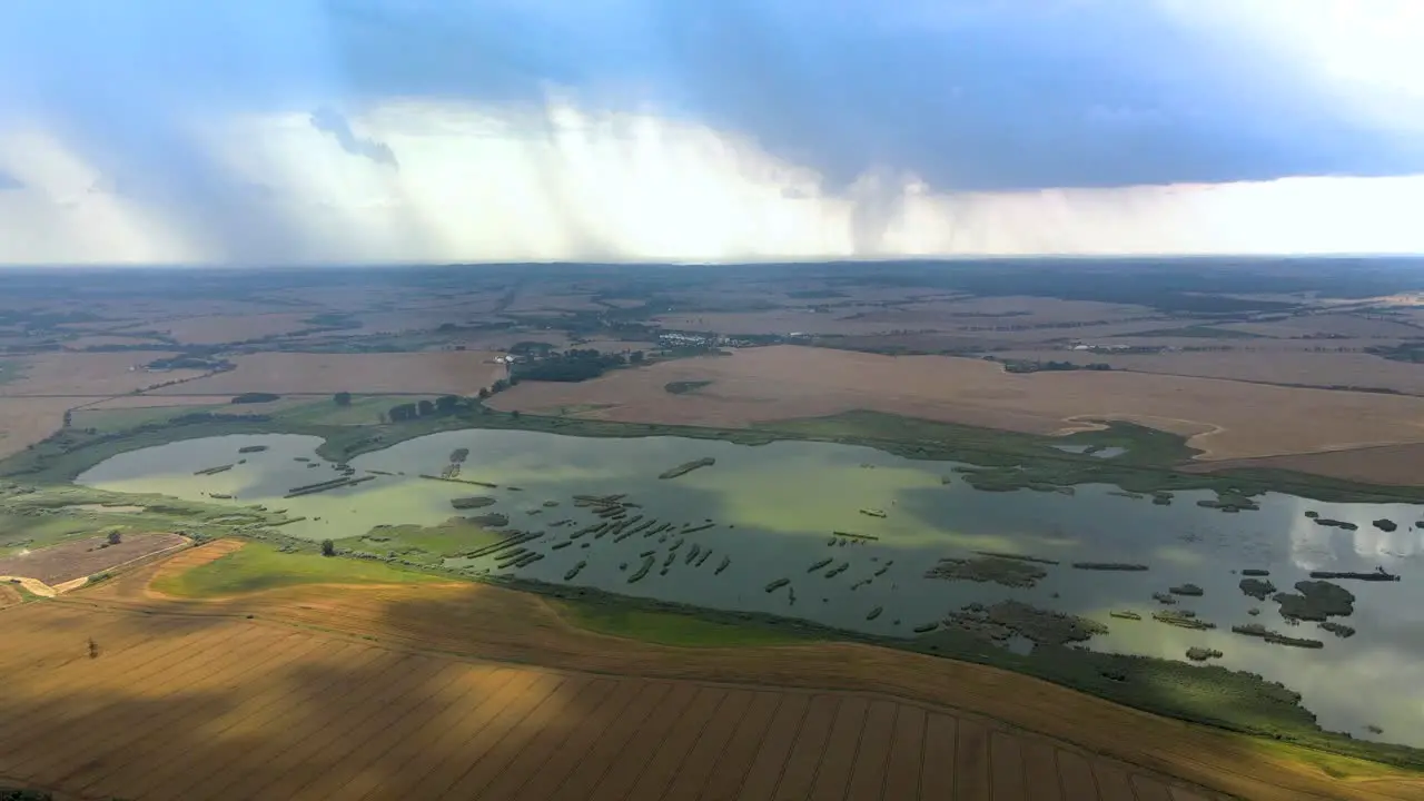 Aerial orbit over the wetlands with the heavy storm in distance