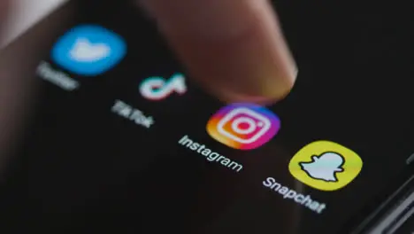 Close Up Shot of Finger Tapping Instagram App On Smartphone Screen