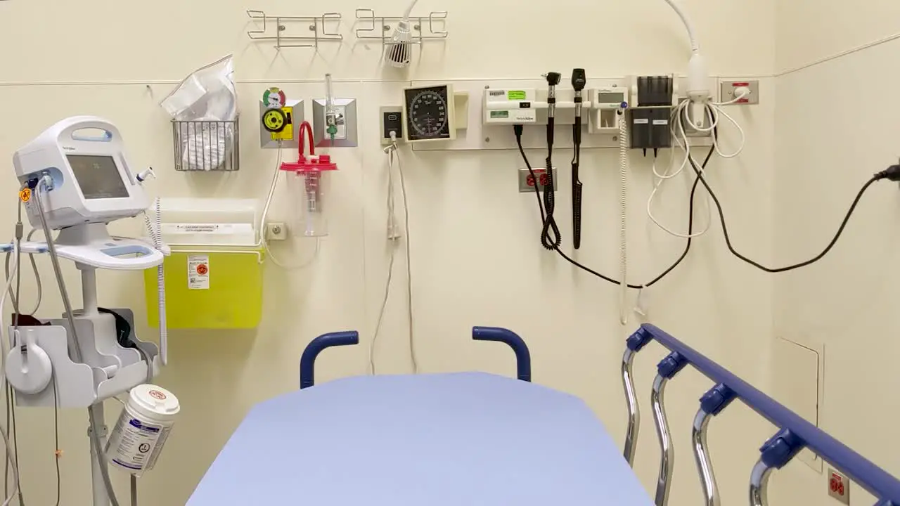 Slow dolly left of an empty medical assessment room ready for a patient