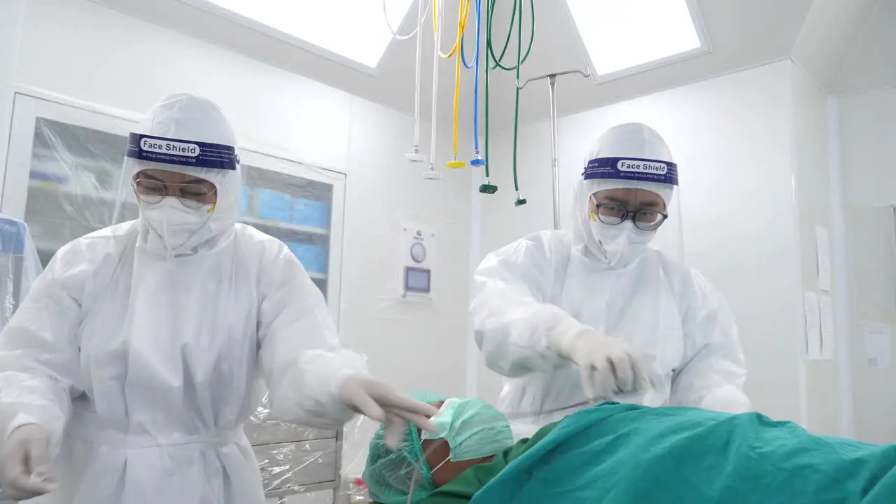 Asian Medical Staff Wear PPE Prepare Patient and Equipment Before Surgery Close Up