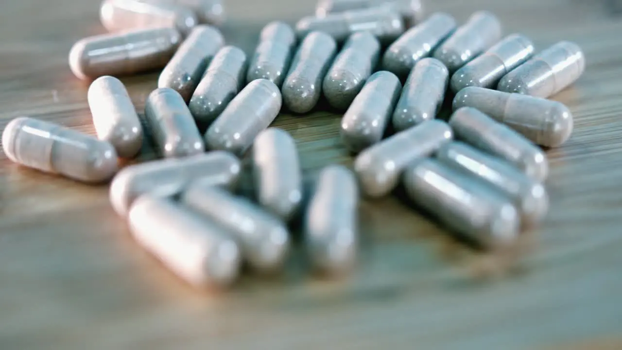 Pills Rotating on a Wooden Surface with a Shallow Depth of Field