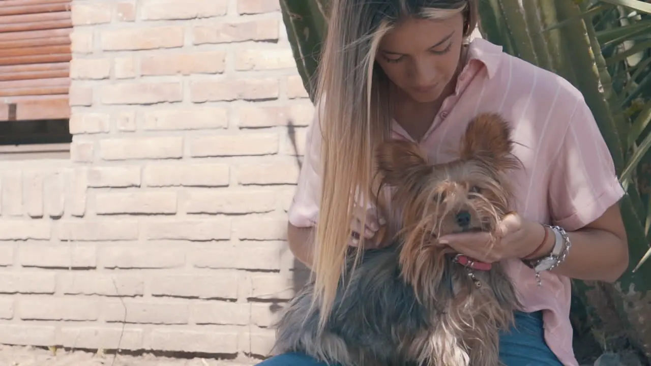 Female Petting Her Little Dog In The Garden