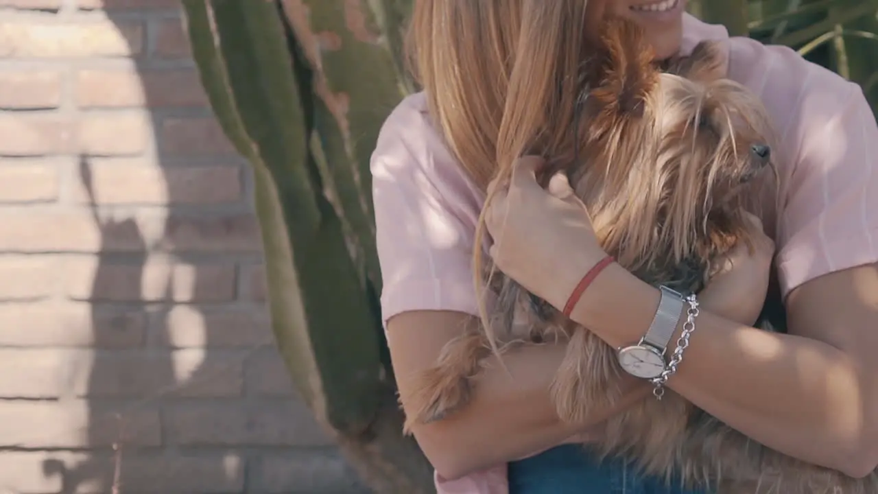 Young Woman Petting Her Little Dog In The Garden 1