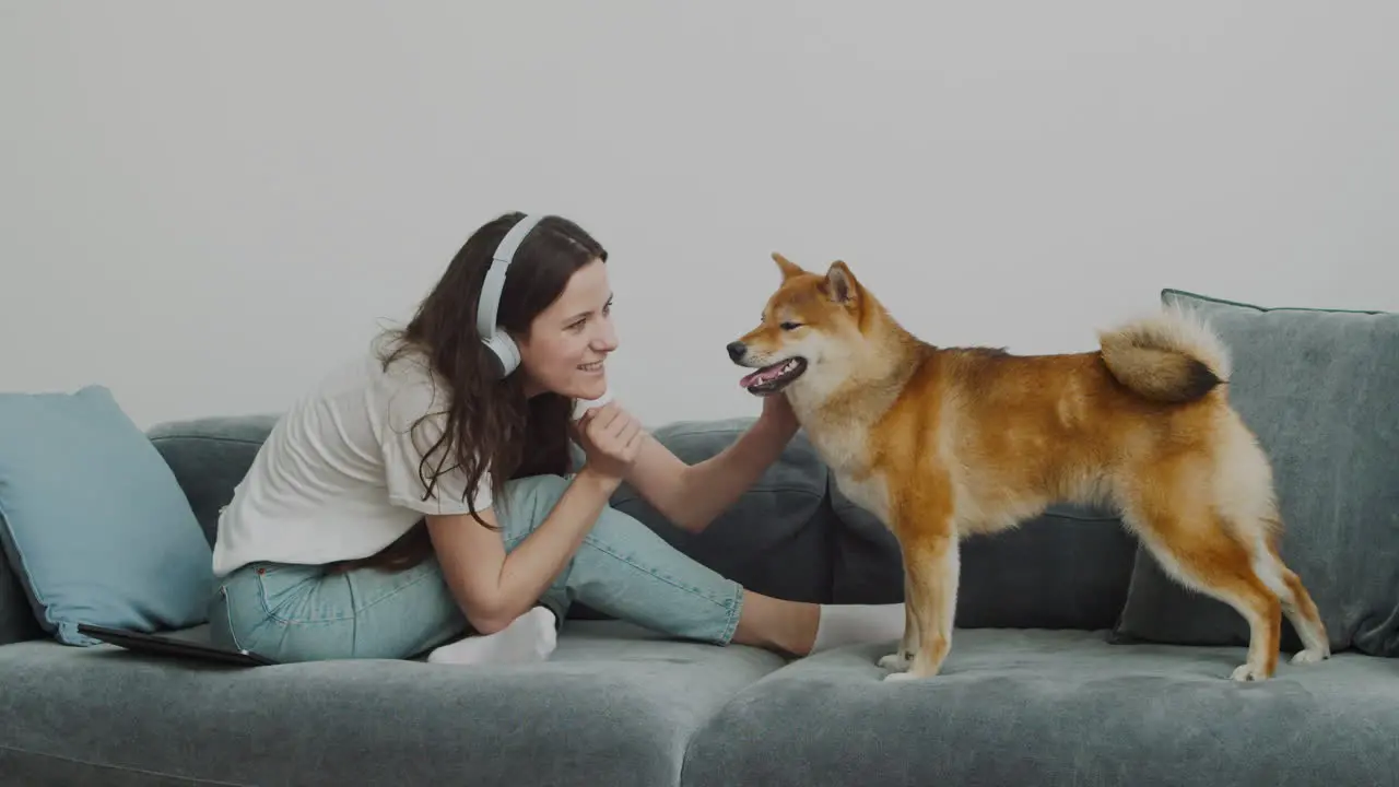 Pretty Girl Petting And Feeding Her Dog At Home 1