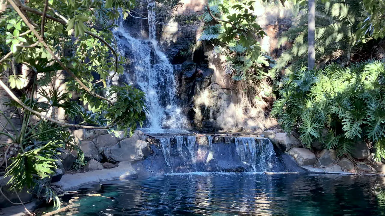 Slo-Mo of stunning waterfall flowing into green peaceful pond Toowoomba Queensland