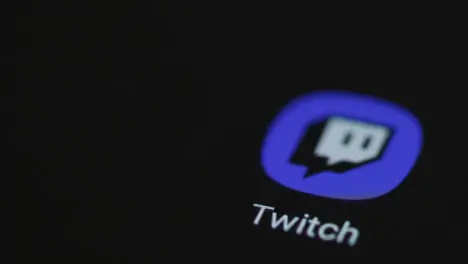 Close Up Shot of Finger Tapping the Twitch App On a Smartphone Screen