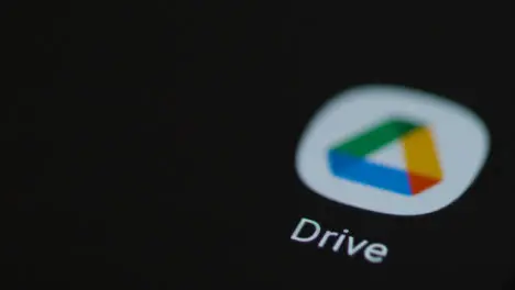 Close Up Shot of Finger Tapping the Google Drive App On a Smartphone