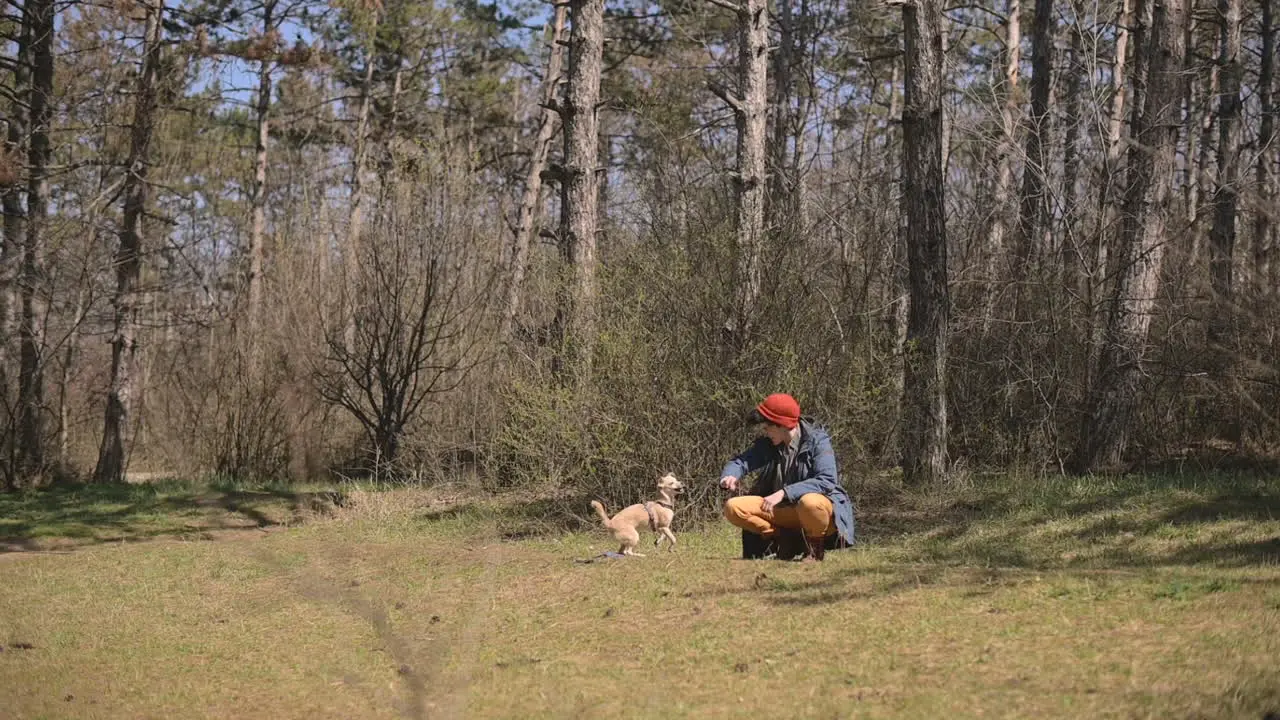 Young Female With Short Hair Plays With Her Dog In The Country