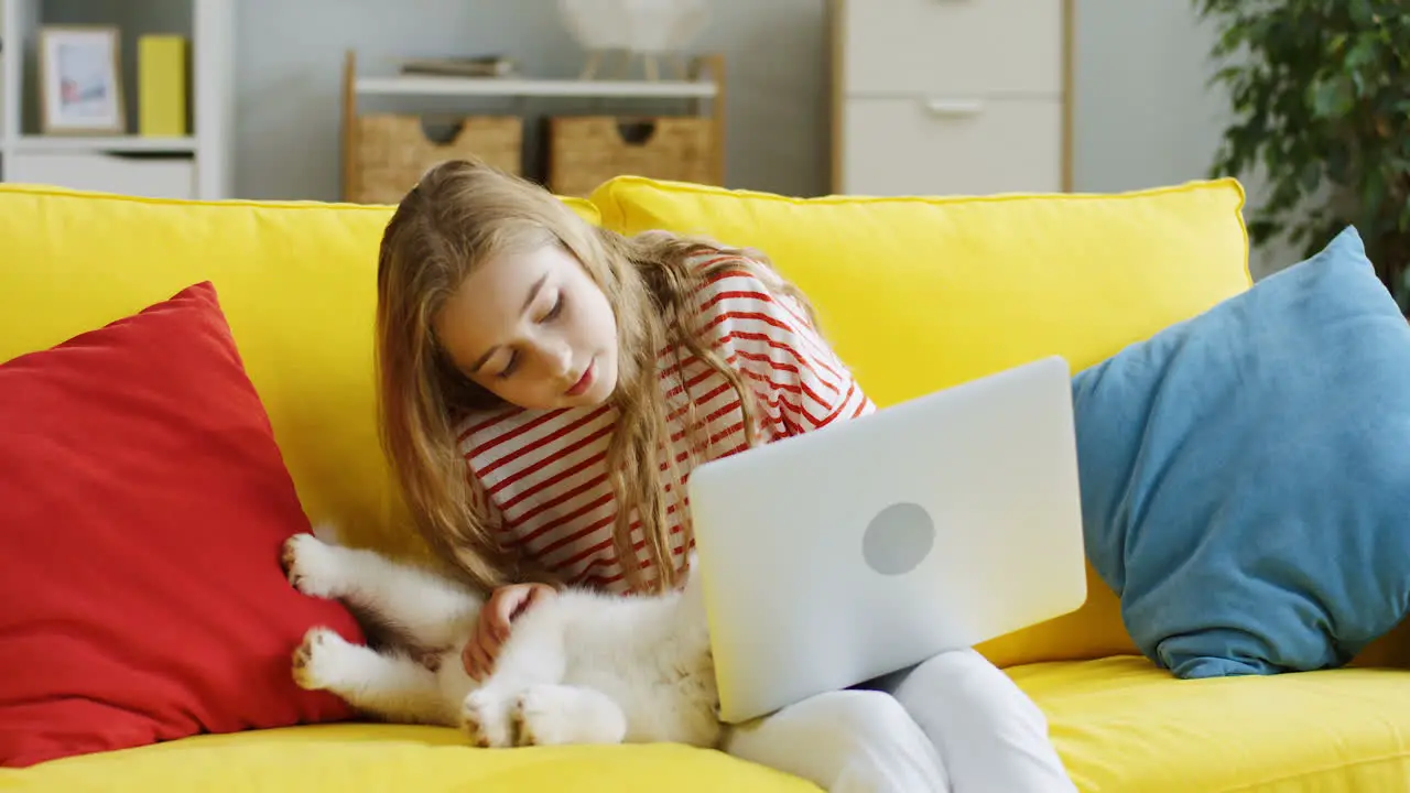 Close Up Of The Cute Teen Girl Petting Her Little Husky Puppy Dog And Playing With It But It Running Away