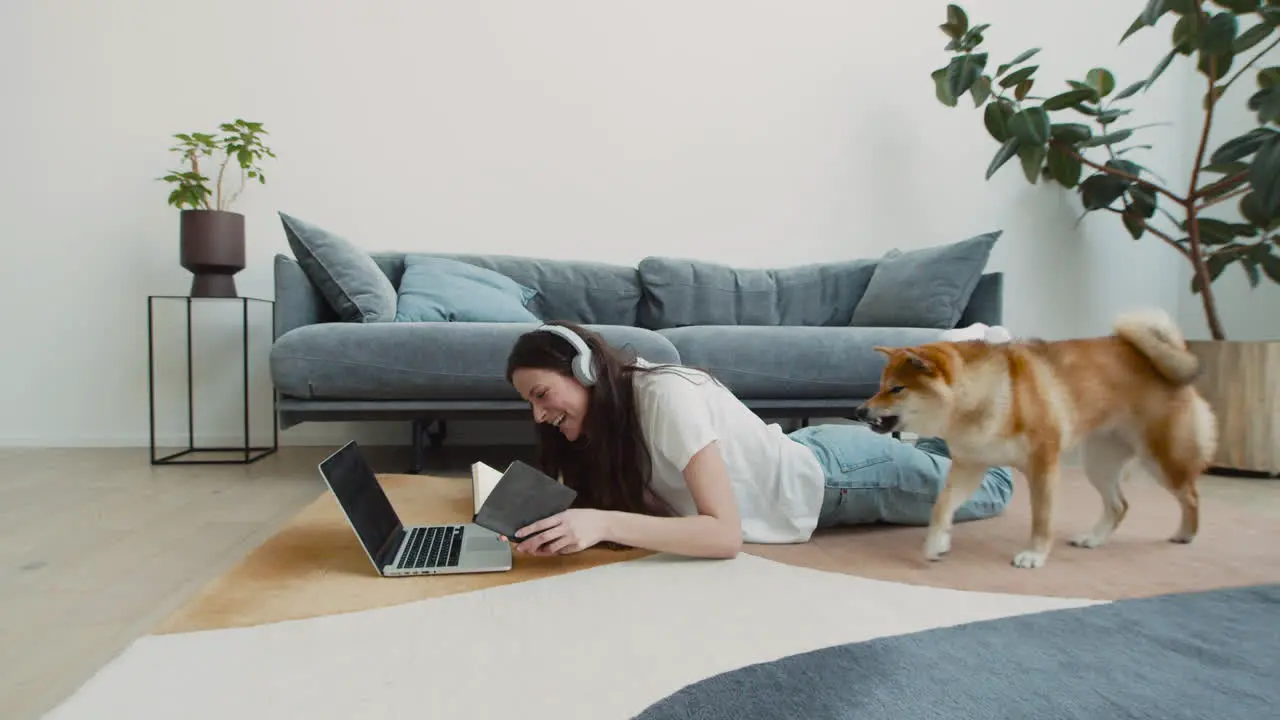 Cute Dog Licks His Owner's Face While She Is Having A Work Video Call On Her Laptop