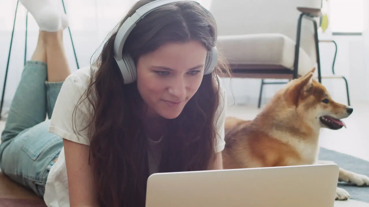 Young Woman Working On Her Laptop At Home Next To Her Dog 6