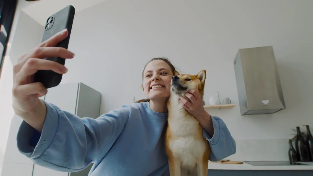 Beautiful Girl Takes A Selfie With Her Dog At Home 1