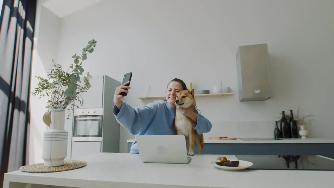 Beautiful Young Woman Takes A Selfie With Her Dog At Home