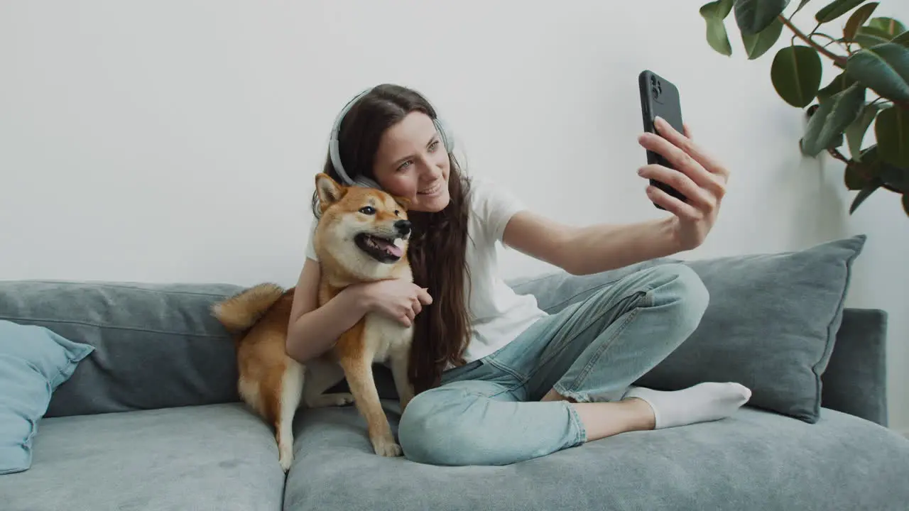 Beautiful Girl Takes A Selfie With Her Dog At Home