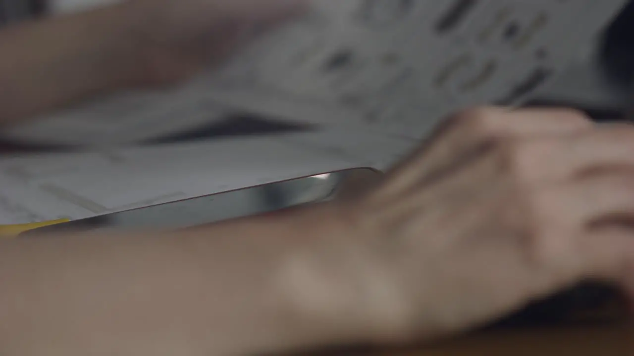 Closeup of female architect sitting on a desk