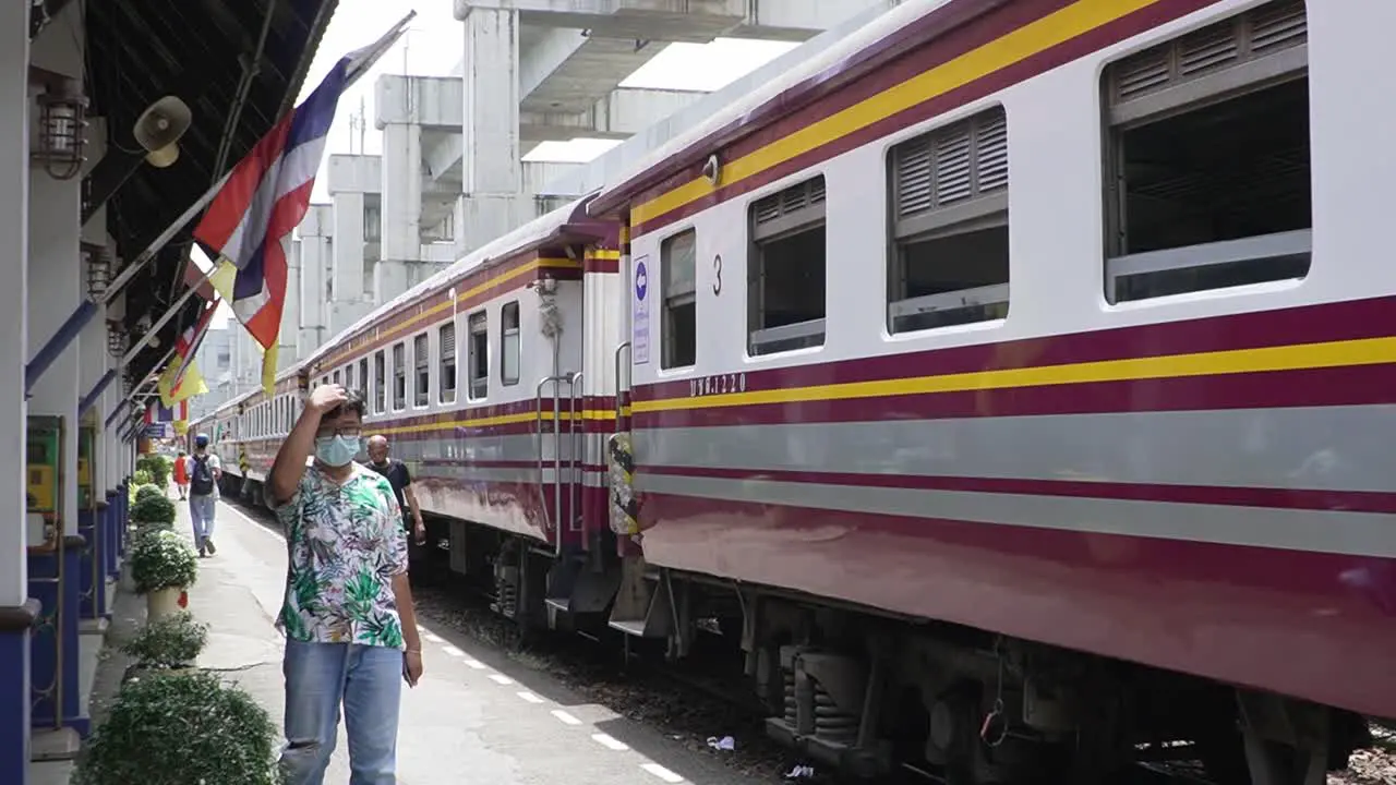 People with mouth masks walking on the train platform