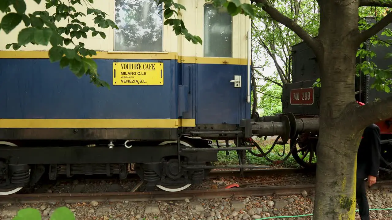 Railway controller crosses scene two times with old steam train in background