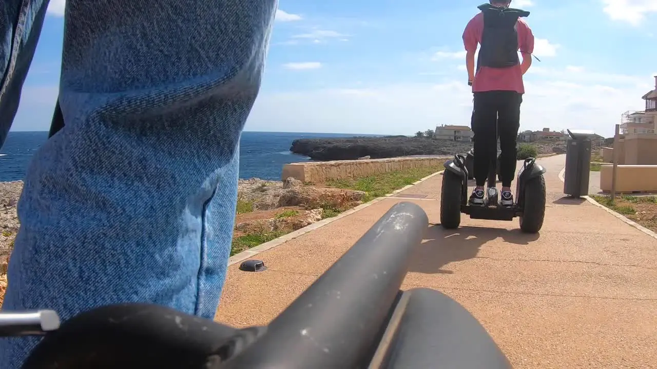 Tourists ride a Segway scooter along the coast of Cala Torta Mallorca