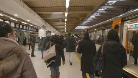 Commuter Passengers Getting Off UK Train At London Euston Station