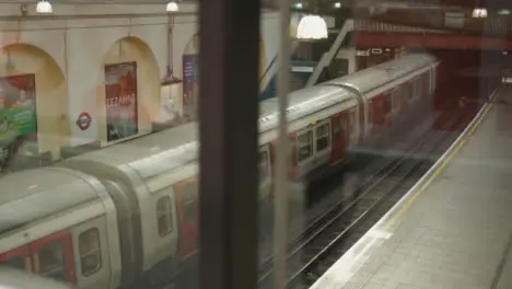 Tube Train Leaving Platform At Underground Station Of Fulham Broadway In London UK