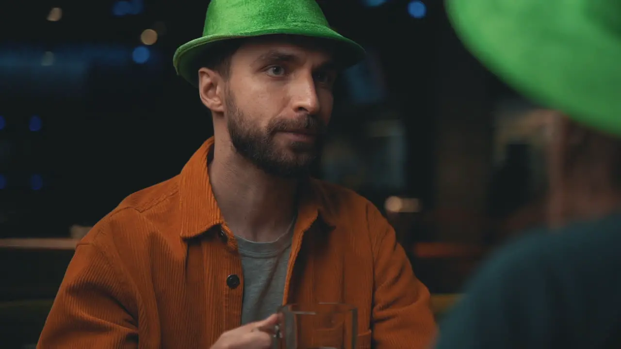 Portrait Of Bearded Man In Irish Hat Talking With Friends In A Pub