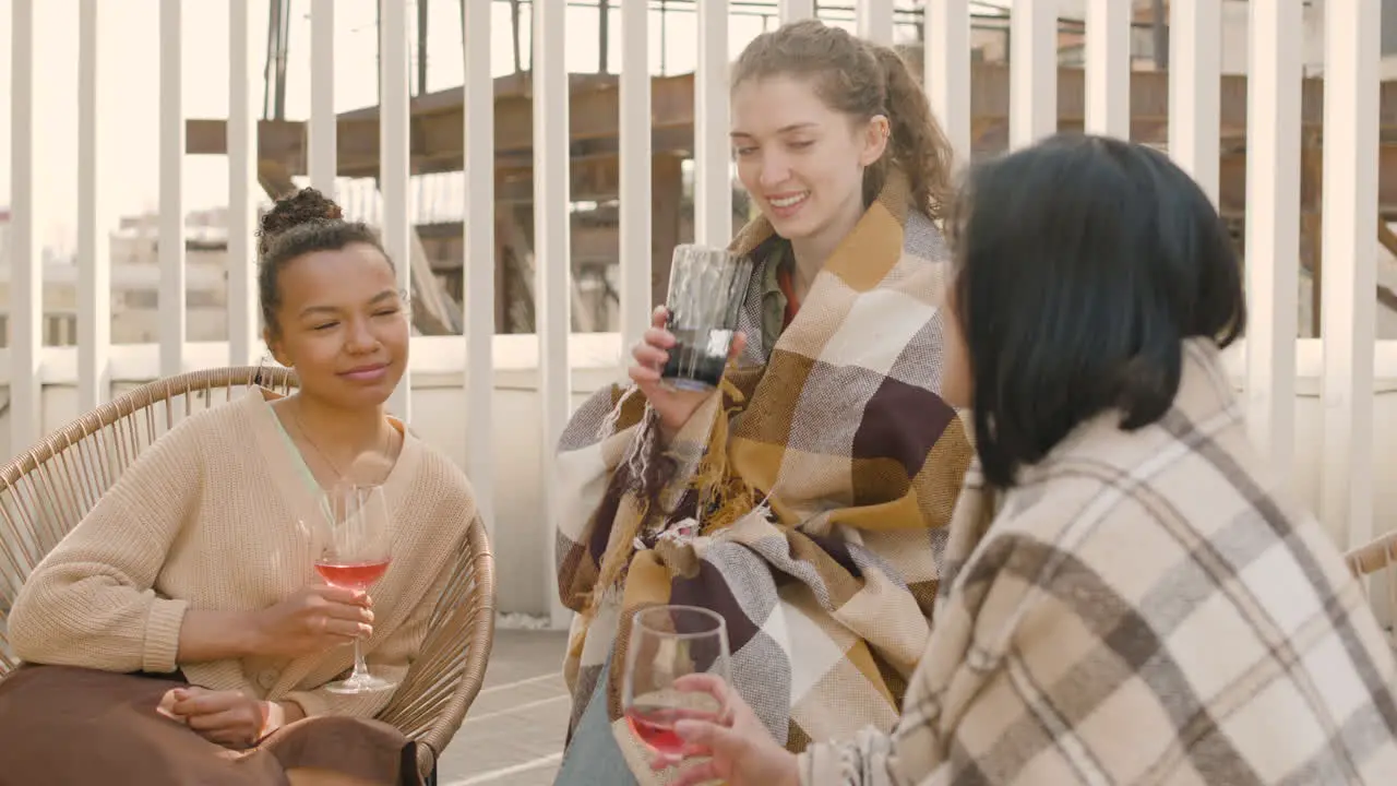 A Nice Multicultural Group Of Three Young Girls Talking And Drinking Wine