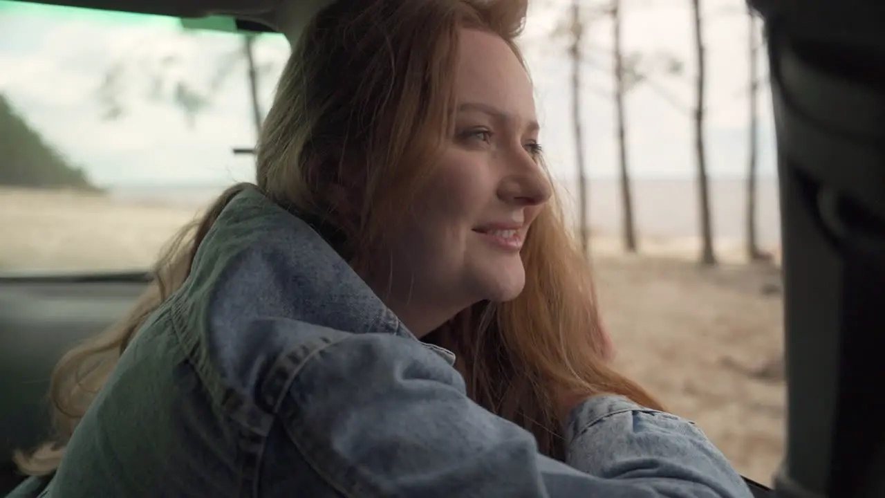 Red Haired Female Enjoys A Drive Through The Countryside Next To The Lake