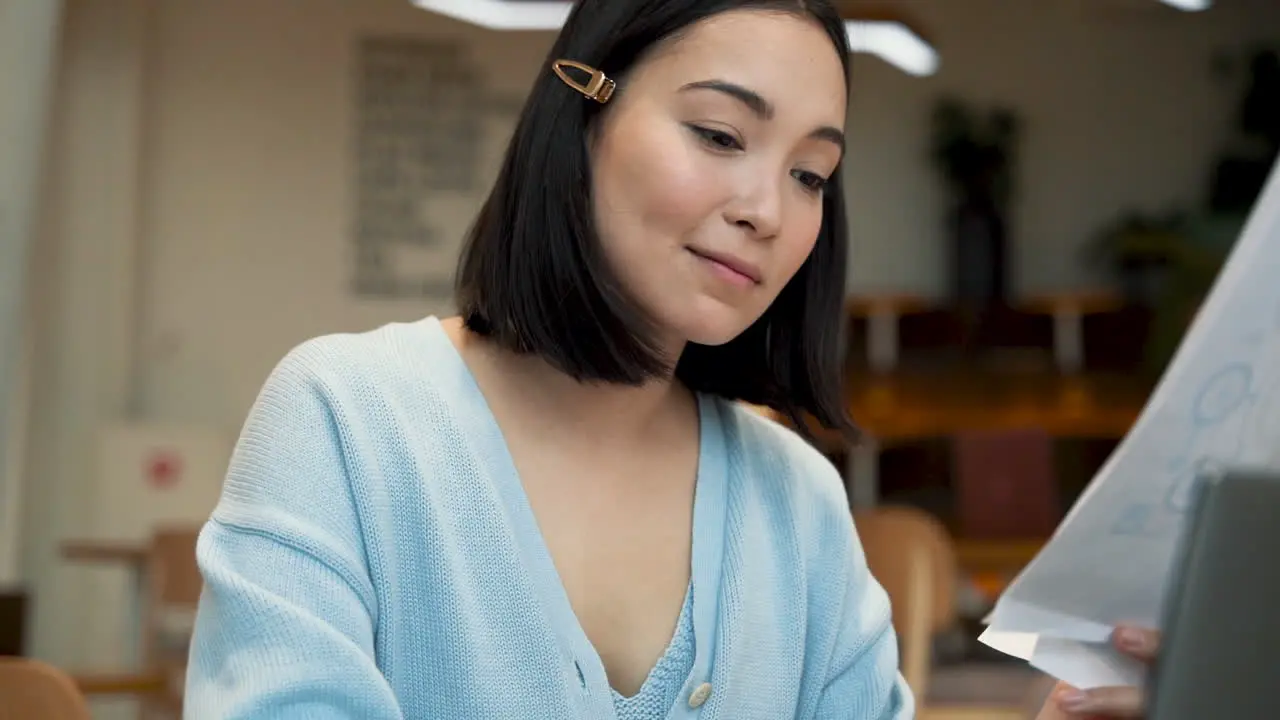 An Business Woman Smiles While Consulting Working Papers In A Coffee Shop 1