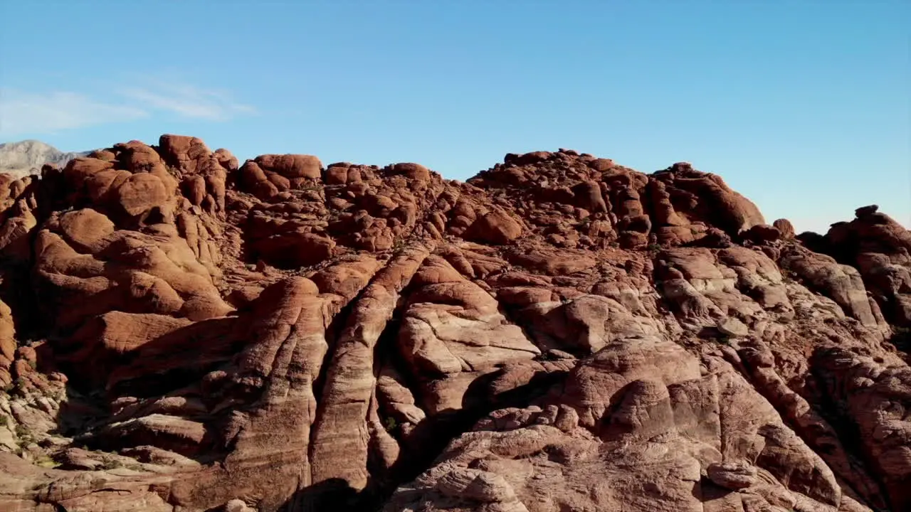 Aerial shot climbing up sandstone mountains Red Rock Canyon Park in Nevada