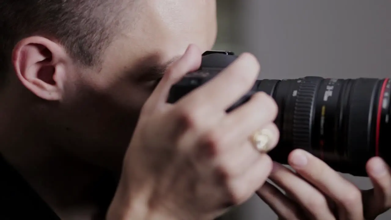 Cameraman Rotating The Zoom Ring Of A DSLR Camera close up