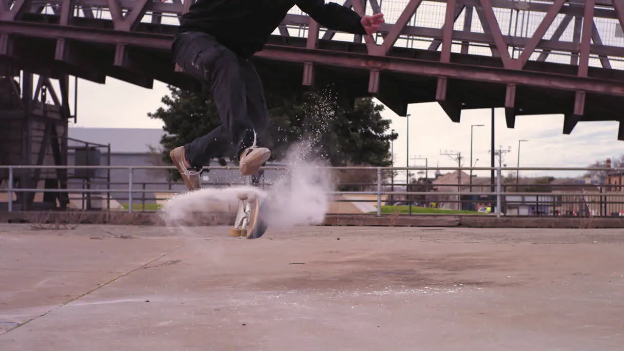 Skateboarder in Super Slow Motion 360 Flip with Powder